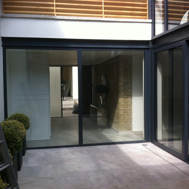 Floor-to-ceiling sliding doors opening to courtyard in Colindale
