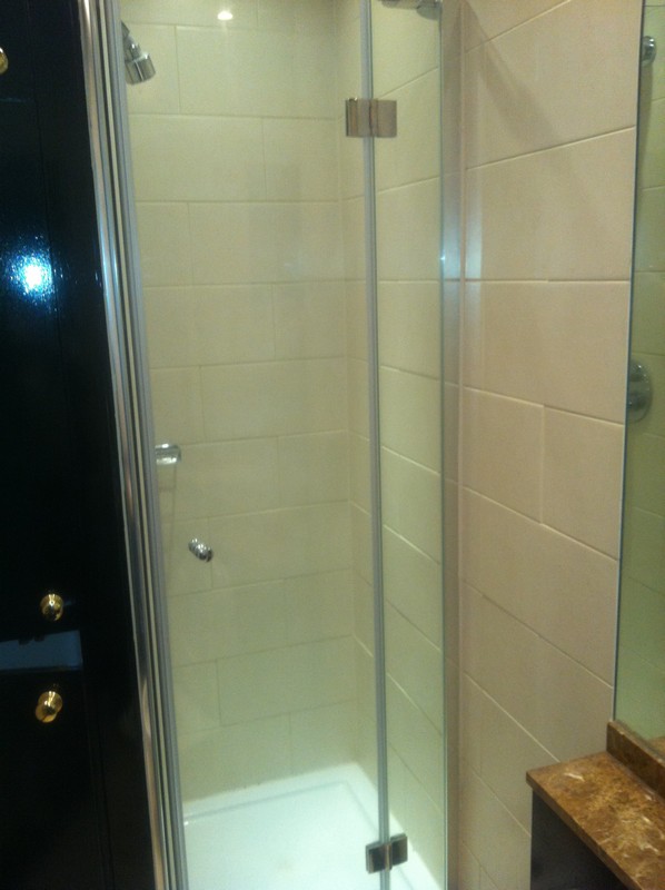 Frameless glass shower enclosure with chrome fittings in Colindale