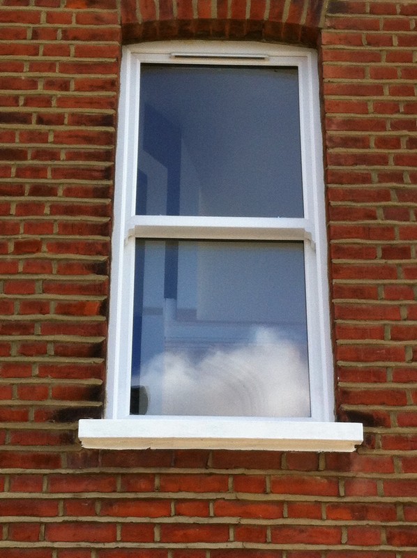 uPVC sash window on Victorian red brick house in Colindale